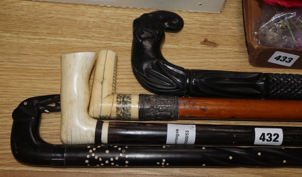 Two Ceylonese ebony elephant handled walking sticks and two Indian ivory handled walking sticks, 19th/early 20th century, longest 95c